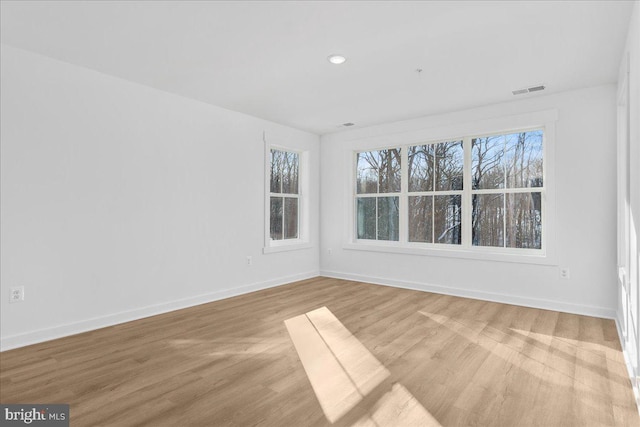 unfurnished room with light wood-type flooring