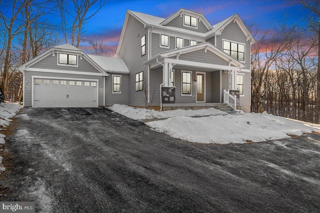 view of front of house featuring a porch and a garage