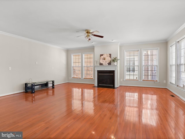 unfurnished living room with crown molding, ceiling fan, and light hardwood / wood-style floors