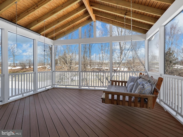 unfurnished sunroom featuring a wealth of natural light, lofted ceiling with beams, and wooden ceiling