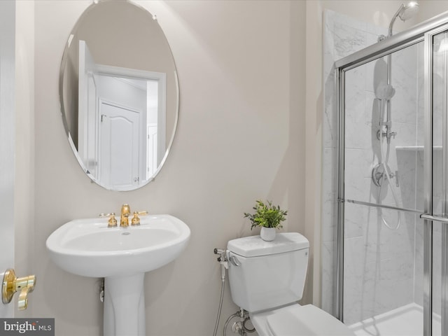 bathroom featuring toilet and walk in shower