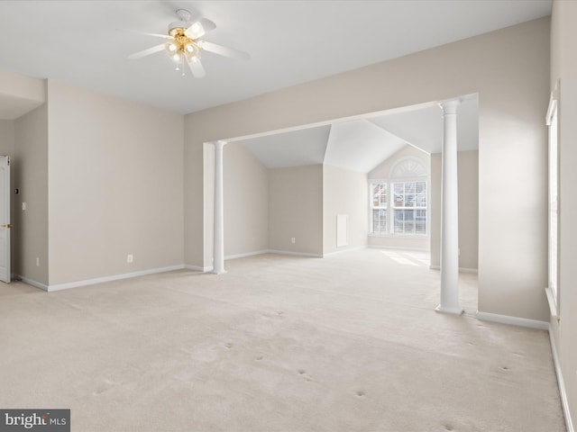 unfurnished living room with light carpet, vaulted ceiling, ceiling fan, and ornate columns