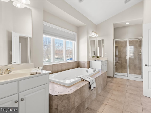 bathroom featuring vanity, plus walk in shower, tile patterned flooring, and vaulted ceiling