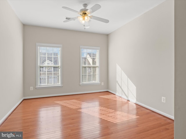 empty room with ceiling fan and light wood-type flooring