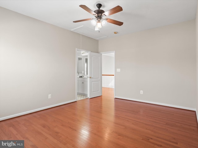 spare room with wood-type flooring and ceiling fan