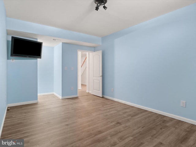 spare room featuring light hardwood / wood-style floors