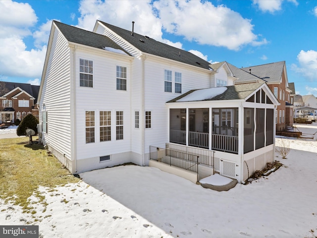 back of house featuring a sunroom