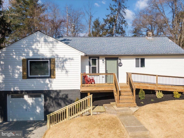 view of front of house featuring a garage and a wooden deck