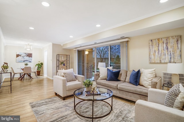 living room with crown molding and hardwood / wood-style flooring