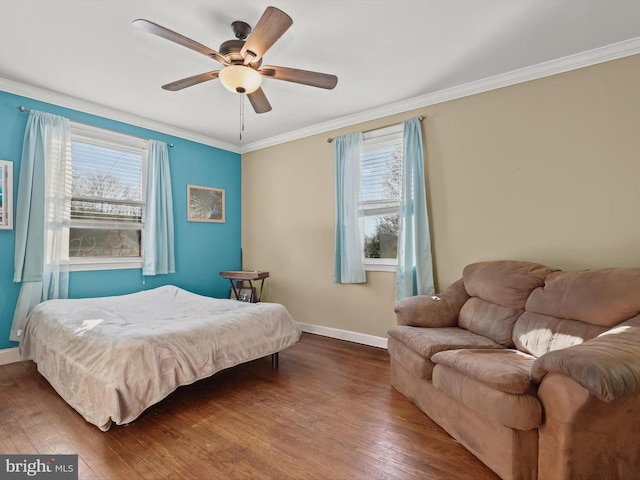 bedroom featuring ornamental molding, dark wood-type flooring, and ceiling fan