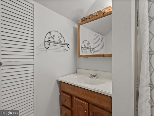 bathroom with vanity and vaulted ceiling