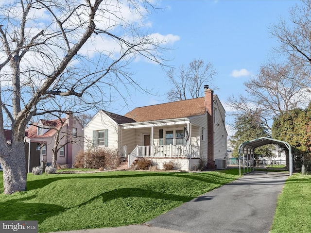 bungalow-style home featuring central AC, a front lawn, a carport, and covered porch