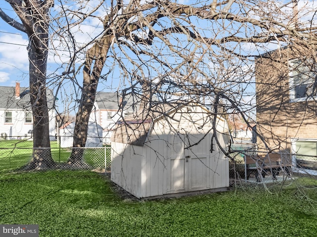 view of side of home with a yard and a shed