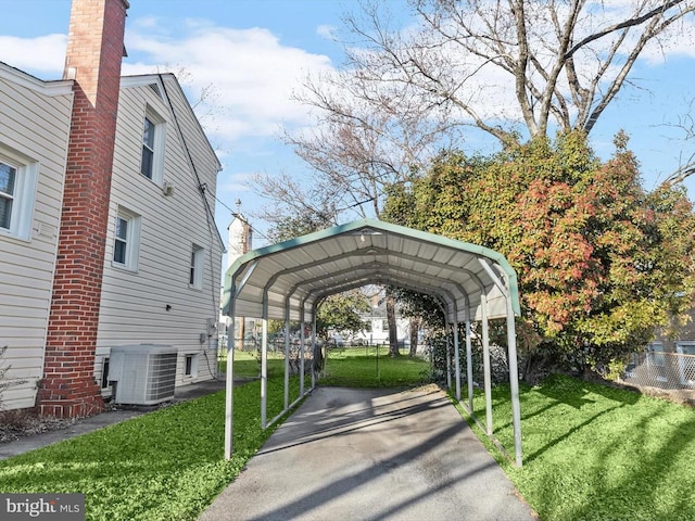 view of vehicle parking featuring a lawn and a carport