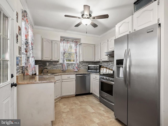 kitchen with stainless steel appliances, ornamental molding, and white cabinets