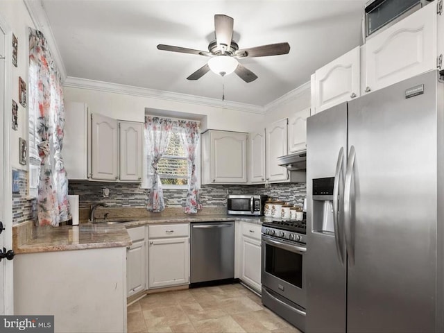 kitchen featuring ornamental molding, appliances with stainless steel finishes, sink, and white cabinets