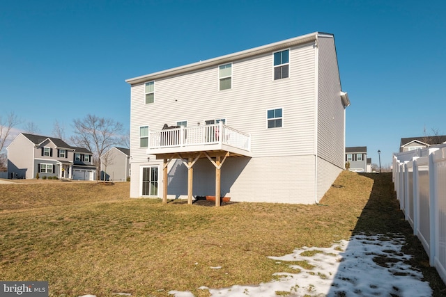 back of house featuring a wooden deck and a yard