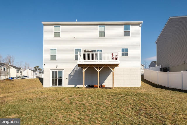 rear view of house featuring a yard and a deck