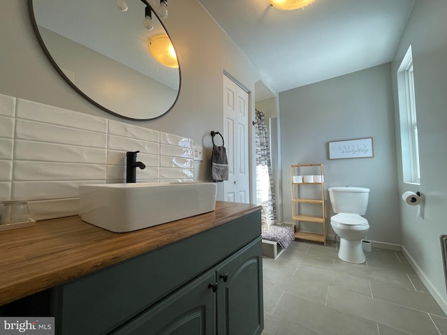 bathroom featuring tile patterned floors, vanity, and toilet