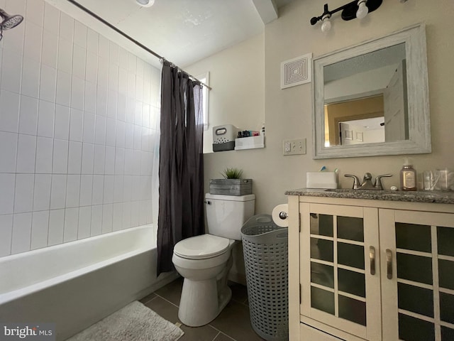 full bathroom featuring vanity, tile patterned floors, toilet, and shower / bath combo with shower curtain