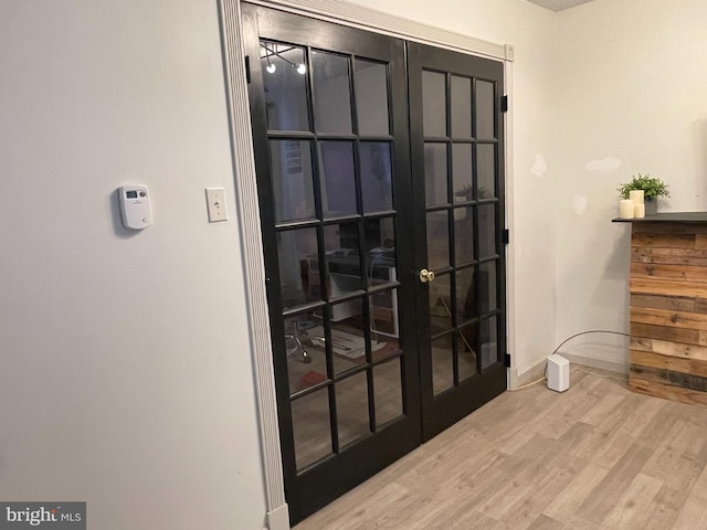 doorway featuring french doors and light wood-type flooring