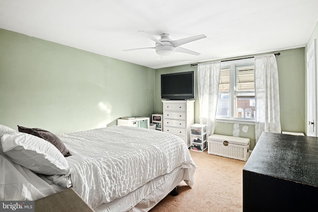 bedroom featuring light carpet and ceiling fan