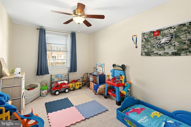 game room with light colored carpet and ceiling fan