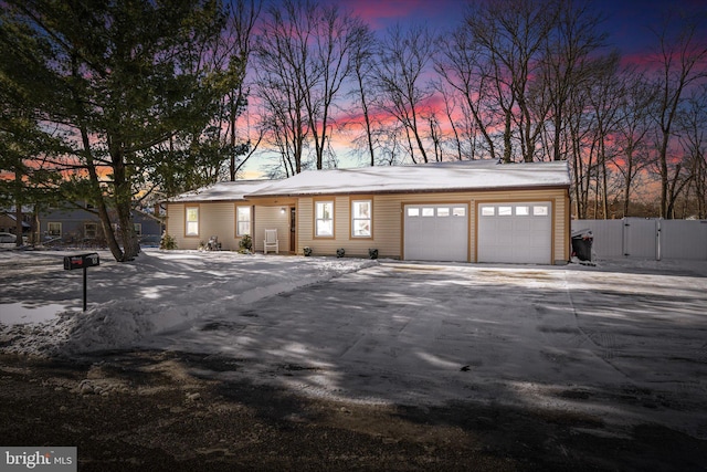 view of garage at dusk