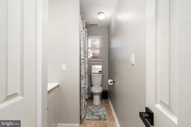 bathroom featuring vanity, toilet, and tile patterned flooring