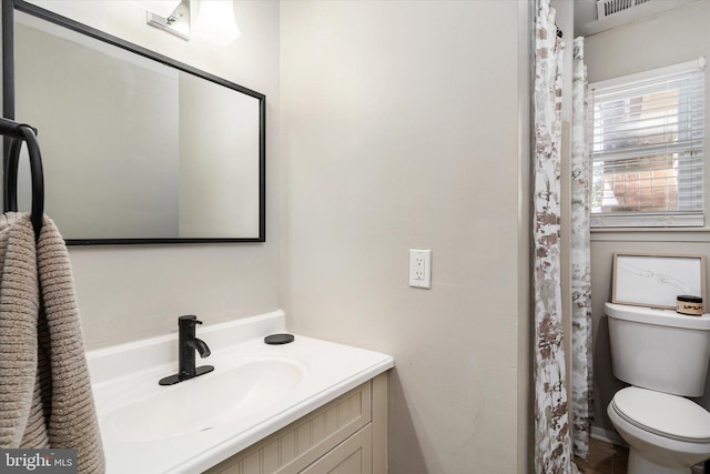 bathroom with vanity and toilet