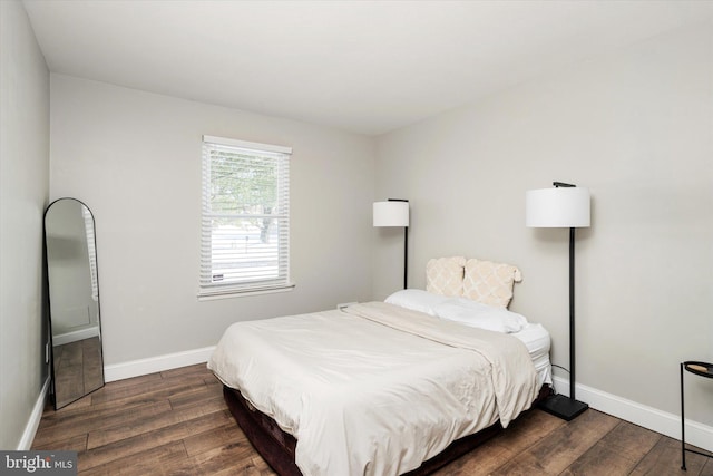 bedroom with dark hardwood / wood-style flooring