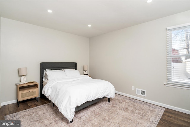 bedroom with dark wood-type flooring