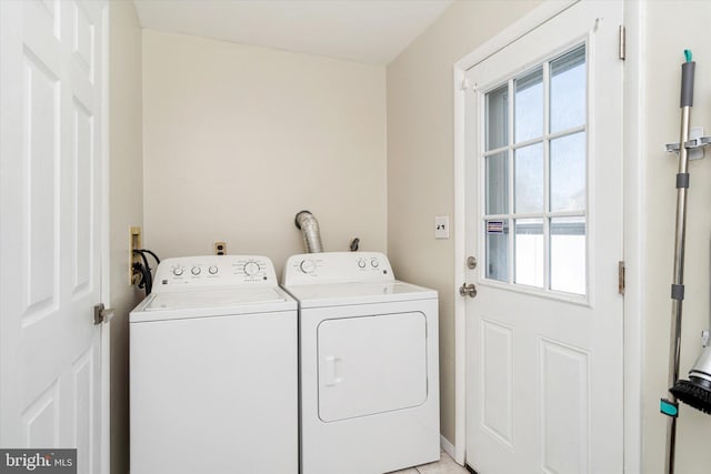 washroom featuring washing machine and dryer and light tile patterned floors