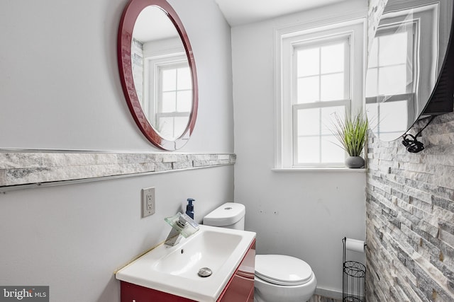 bathroom with vanity, plenty of natural light, and toilet