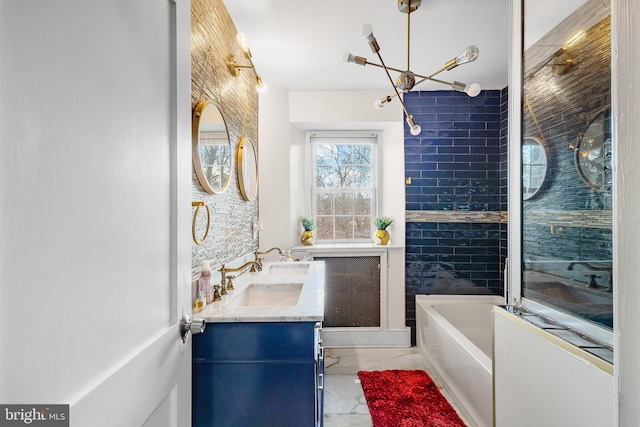 bathroom featuring tiled shower / bath and vanity