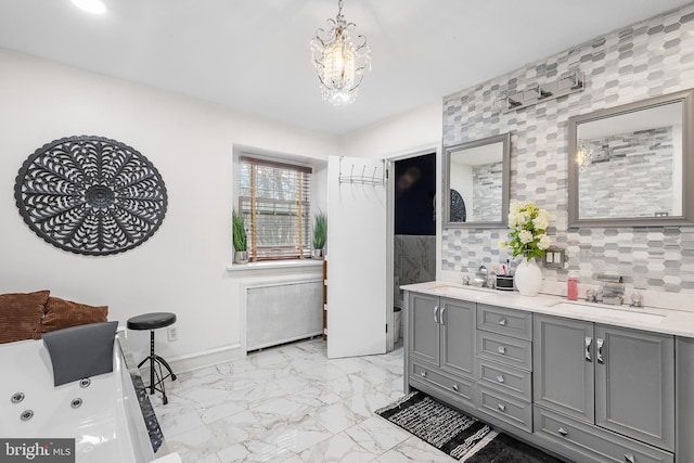 bathroom with a washtub, backsplash, radiator heating unit, vanity, and a chandelier