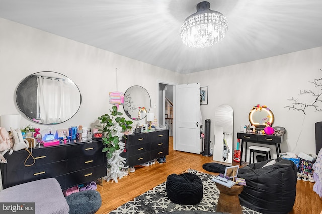 bedroom with an inviting chandelier and wood-type flooring