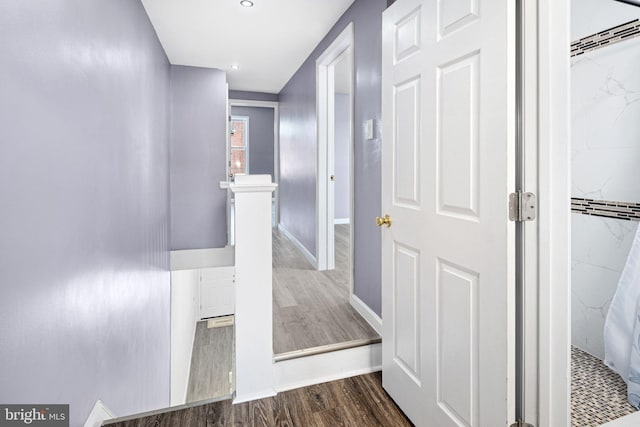 hallway with hardwood / wood-style flooring