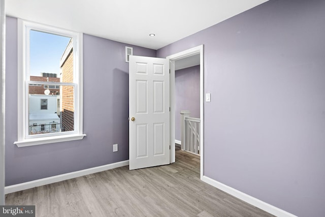 unfurnished bedroom with light wood-type flooring