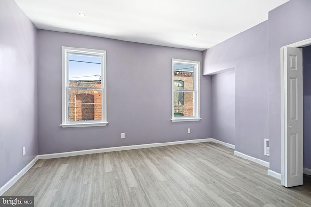 unfurnished room featuring light hardwood / wood-style floors and a healthy amount of sunlight