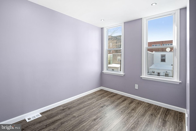 spare room featuring dark hardwood / wood-style flooring