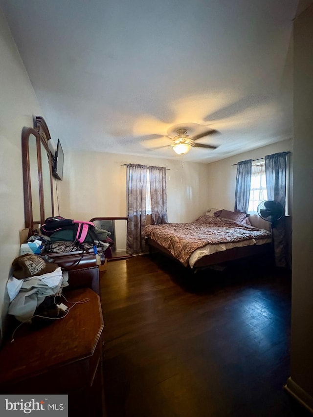 bedroom with ceiling fan and dark hardwood / wood-style floors