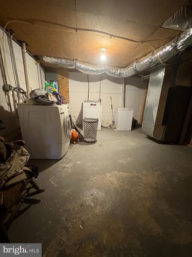 basement with washing machine and dryer and fridge