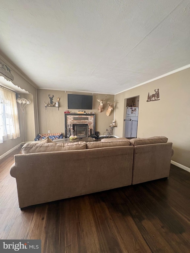 living room with hardwood / wood-style flooring, a brick fireplace, and a textured ceiling