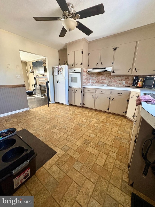 kitchen with ceiling fan, white appliances, and white cabinets