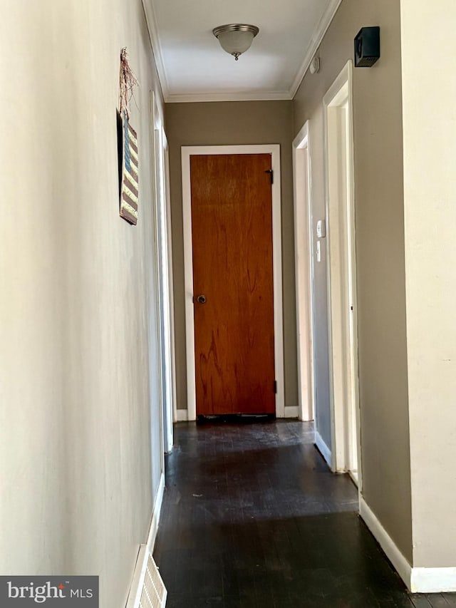 hall with ornamental molding and dark hardwood / wood-style floors