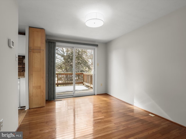 unfurnished room with light hardwood / wood-style flooring