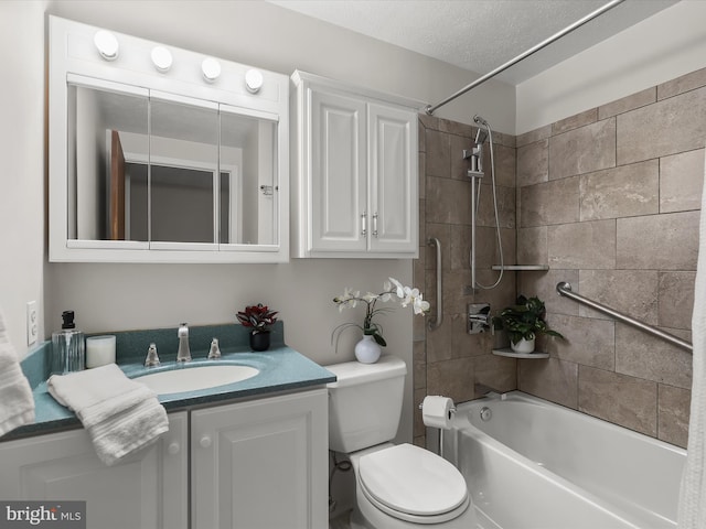 full bathroom featuring vanity, toilet, tiled shower / bath combo, and a textured ceiling