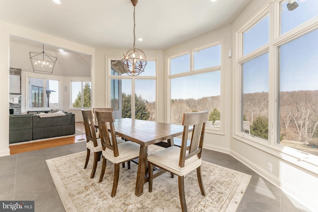 dining room featuring recessed lighting, baseboards, and an inviting chandelier