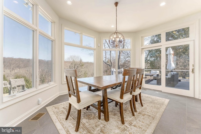 dining area featuring a chandelier, recessed lighting, and baseboards